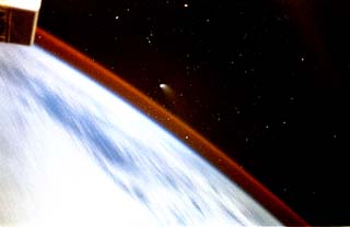 Photograph of the Comet Hale-Bopp as it sets over the Earth limb